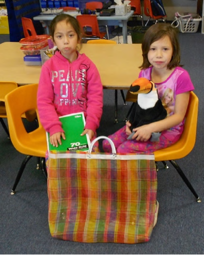 
Karen and Luz posing with the bag containing their family journal and the stuffed animal (a toucan named Tomás)
